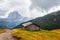 Mountain meadow and houses in Gardena valley and Seceda peak , background Alpe di Siusi or Seiser Alm in the with Province of