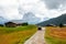 Mountain meadow and houses in Gardena valley and Seceda peak , background Alpe di Siusi or Seiser Alm in the with Province of