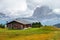 Mountain meadow and houses in Gardena valley and Seceda peak , background Alpe di Siusi or Seiser Alm in the with Province of