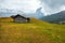 Mountain meadow and houses in Gardena valley and Seceda peak , background Alpe di Siusi or Seiser Alm in the with Province of