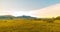 Mountain meadow time-lapse at the summer or autumn sunset time. Wild nature and rural field. Clouds movement, green