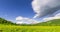 Mountain meadow time-lapse at the summer or autumn time. Wild nature and rural field. Clouds movement, green grass and