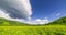 Mountain meadow time-lapse at the summer or autumn time. Wild nature and rural field. Clouds movement, green grass and