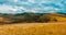 Mountain meadow time-lapse at the summer or autumn time. Wild nature and rural field. Fast clouds movement, green grass