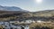 Mountain meadow timelapse at the summer or autumn time. Wild nature and rural valley. Sun rays, small creek and yellow