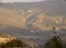 Mountain, misty landscape.In the valley there is a small town, above it rise the mountains covered with forest