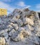 Mountain of packed snow from the streets and squares of Saint- Petersburg against the sky