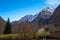 Mountain panorama with peaks, snow, villages, streams and trails