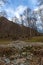 Mountain panorama with peaks, snow, villages, streams and trails