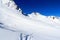 Mountain panorama with snow and snowshoe trail in winter in Stubai Alps