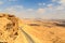 Mountain panorama and street in crater Makhtesh Ramon, Negev Desert, Israel
