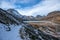 Mountain path with snow with a view of the Silvretta dam in Austria near the Italian border