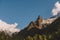 Mountain peak Belalakaya with clouds and blue sky. Wild nature view. Dombay ski resort, Russia, Caucasus mountain.