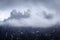 Mountain peak hiding behind the clouds and fog on the highland plateau in Dolomites, South Tyrol, Italy