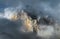 Mountain peak peeking through clouds in Caucasus mountains.