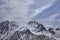 Mountain peaks and glaciers. Rocks and corridors under the blue sky.