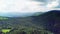 Mountain peaks and morning sky with smooth moving clouds. Summer landscape paeceful valley trees in the meadow at