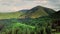 Mountain peaks and morning sky with smooth moving clouds. Summer landscape paeceful valley trees in the meadow at