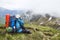 Mountain photographer and hiker with backpack and equipment outdoor on mountain peak