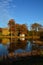 The mountain pond acts reflects the old shed and fall colors of the trees