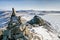 Mountain range with a green texture and rocks covered of snow above the frozen lake