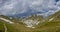 Mountain range with a lake and a rocky snowy valley