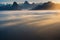 a mountain range with a low lying cloud in the foreground and a low hanging cloud in the background