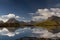 Mountain range of Moskenes reflecting in a fjord