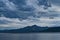 Mountain range and sea during thunderstorm