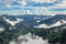 Mountain range valley filled with low clouds with dramatic sky at morning