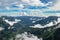 Mountain range valley filled with low clouds with dramatic sky at morning