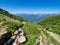 Mountain range and valley with residential houses, view from a height. Mountain stream