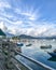 Mountain, recreational wooden boats, clouds, lake, blue sky and sun in Hong Kong