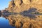 Mountain with reflections in a river, Fint Oasis.