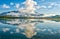 Mountain Reflections in a vivid blue glacial lake on the Alaskan