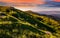 Mountain ridge with peak behind the hillside at sunset