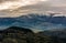 Mountain ridge with snowy peak on gloomy day