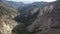 Mountain Ridges Aerial Shot of Forest and Cliff Backward Tilt Up