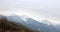 Mountain ridges covered with snow and overcast sky