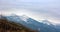 Mountain ridges covered with snow and overcast sky