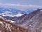 Mountain ridges, red trees and snow covered land