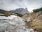 The mountain river against the sharp mountains in Dolomites