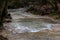 Mountain river in the autumn forest. Streams of water on a long exposure