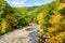 Mountain River in Autumn under Blue Sky