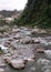 Mountain river Baner flowing through the stones in Himachal Pradesh