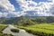 Mountain River Flowing along Canyon, Green Hills and Blue Sky with White Clouds