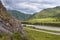 Mountain River Flowing along Little Canyon with Green Forest