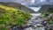 Mountain river flowing from Black Lake in Gap of Dunloe. Green hills at sunset in Black Valley