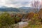 The mountain river flows in the autumn colored valley.