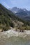 a mountain river flows through the valley it has formed with some mountains with some snow in the background, Ara river, Bujaruelo